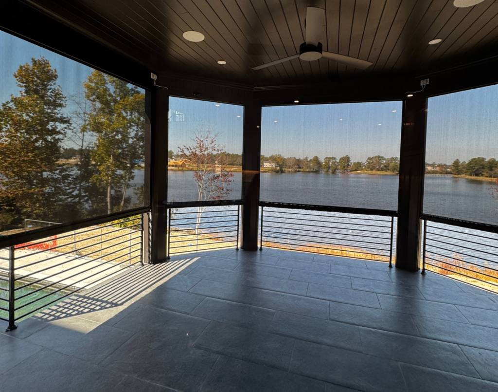 Lakeside patio at sunset covered by professionally installed retractable screens.