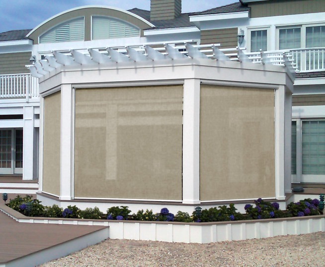 Beige exterior motorized retractable screens.