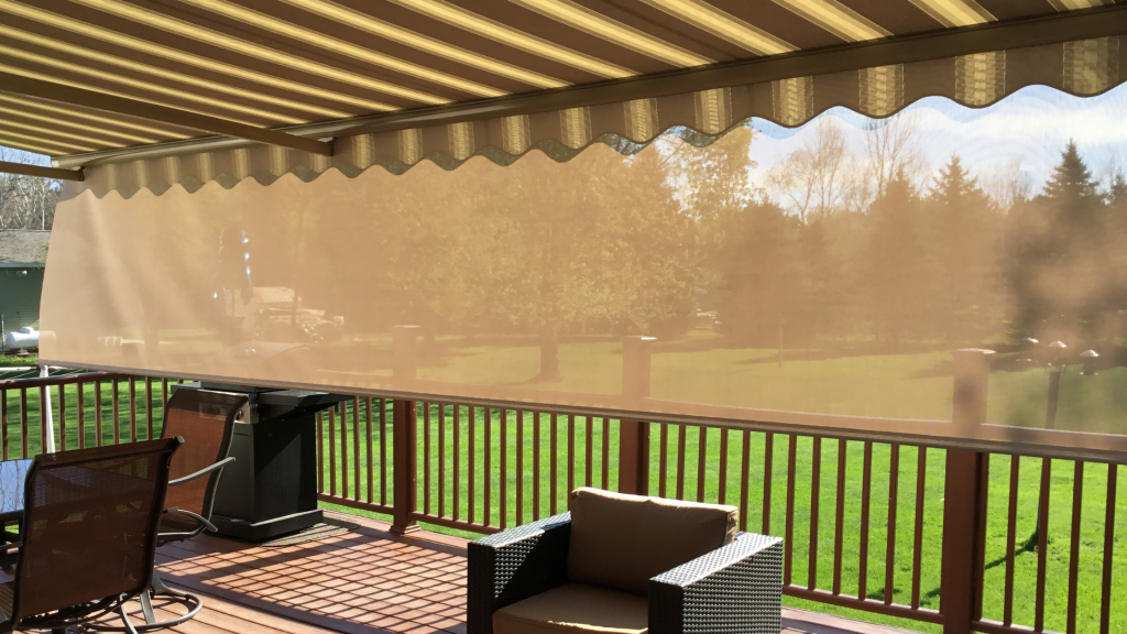 Retractable awning with an attached drop down shade.