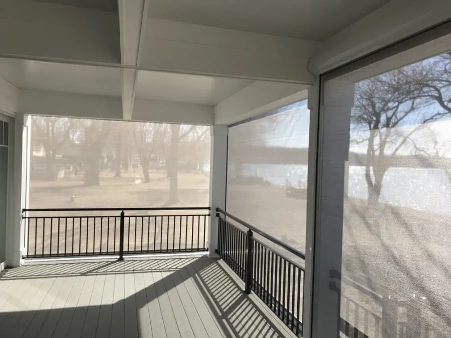An indoor view of retractable screens lowered around a porch