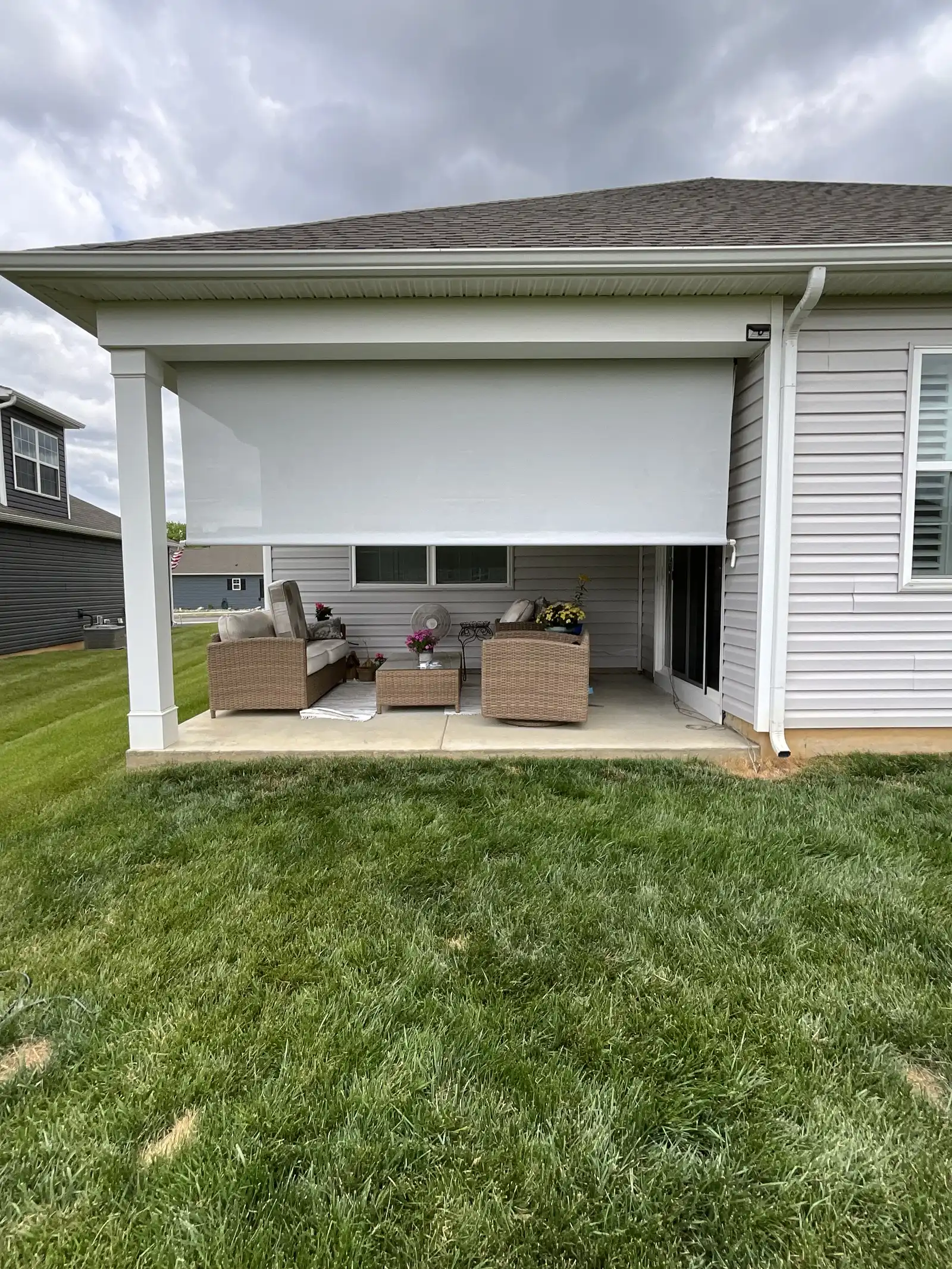Retractable screens partly lowered on a covered patio