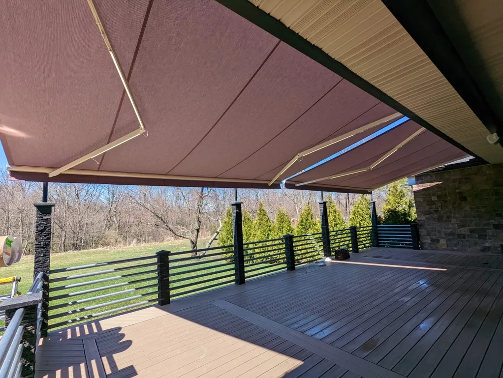 Looking out from under a retractable awning over a large commercial deck